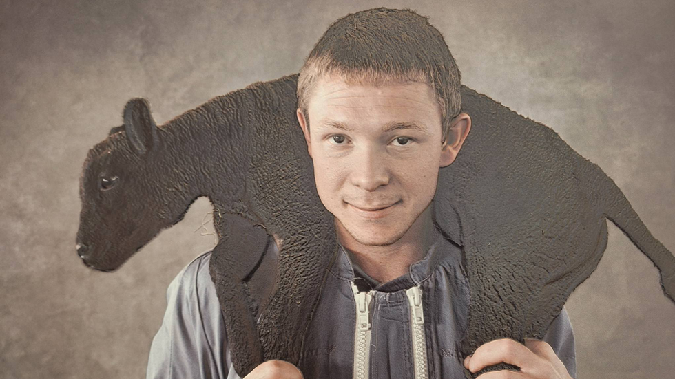 A picture of a boy that carries a sheep over his shoulders. The picture has been made tactile.